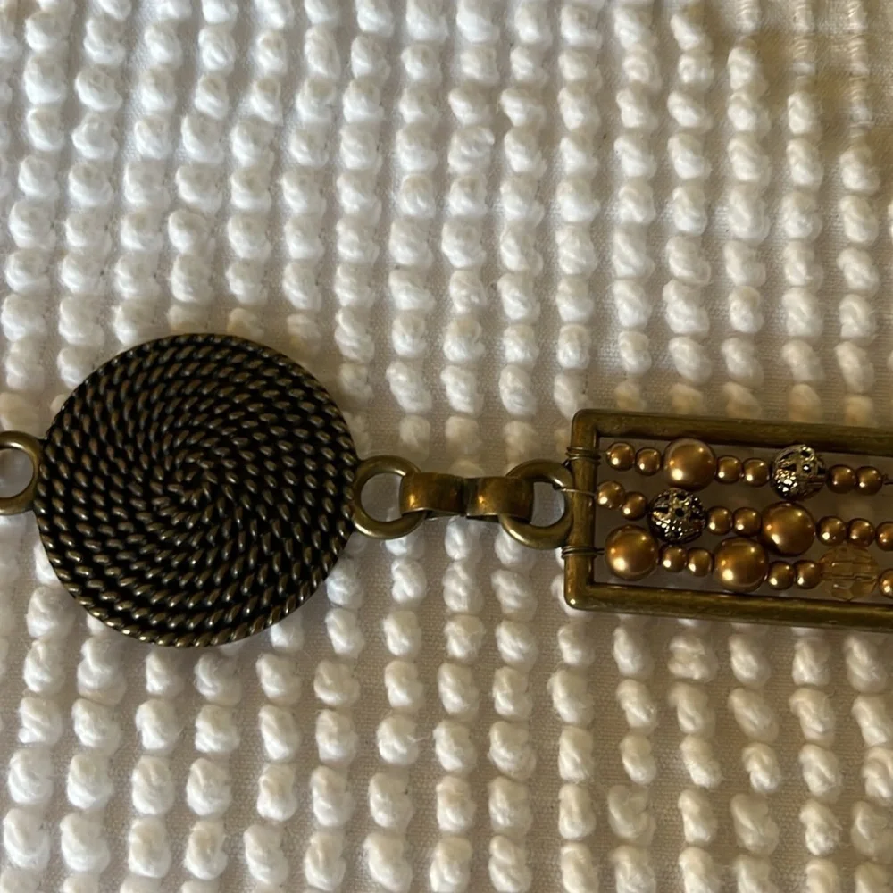 Women’s chain with metal circular and rectangular patterns belt.
